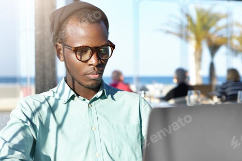 Preview: Serious Concentrated Dark-Skinned Fashionable Student Having Frustrated Look While Working On His