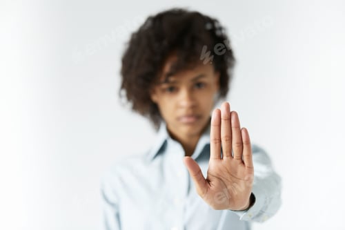 Preview: Selective Focus On A Palm Of African Teenage Girl With Long Thin Fingers, Looking At The Camera