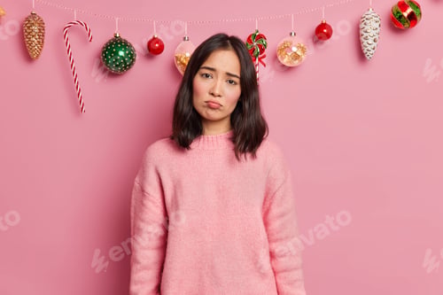 Preview: Sad Gloomy Woman With Dark Hair Wears Casual Jumper Looks Unhappily At Camera Has Spoiled Mood On