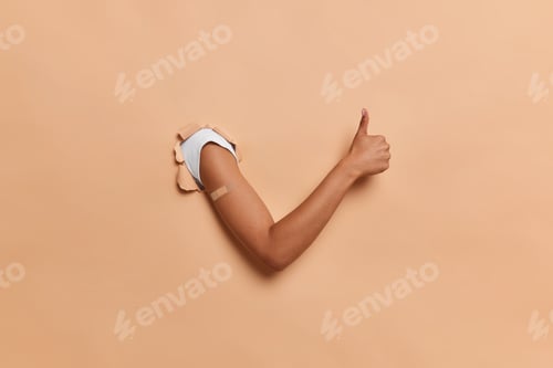 Arm Breaking Through Wall with Thumbs Up
