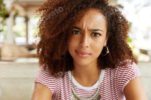 Preview: Close Up Shot Of Discontent Female With Pure Dark Skin, Looks With Dissatisfied Expression As
