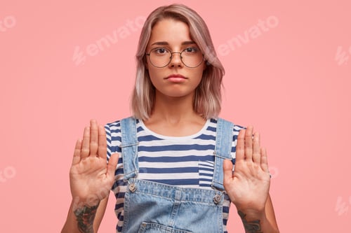 Vista previa: Serious Beautiful Female Keeps Palms In Front Shows Rejection And Refusal, Wears Casual Clothes