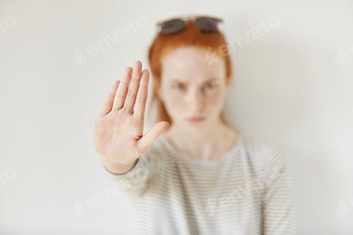 Preview: Young Annoyed Woman With Bad Attitude Making Stop Gesture With Her Palm Outward, Saying No