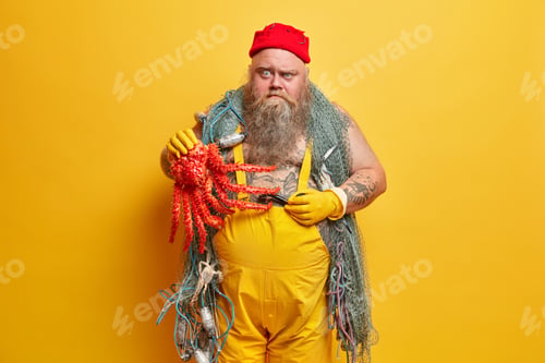 Preview: Photo Of Serious Bearded Fisherman Caught Octopus While Angling Holds Smoke Pipe Poses With Fishing