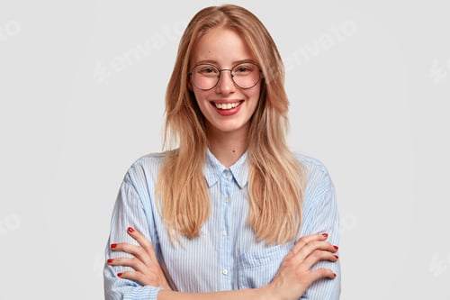 Preview: Portrait Of Cheerful European Female With Satisfied Expression, Dressed In Shirt And Spectacles