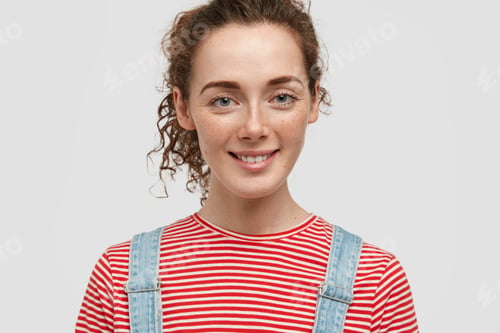 Preview: Close Up Shot Of Attractive Freckled Woman With Curly Hair, Smiles Positively, Being In Good Mood