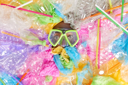 Preview: Dark Skinned Man Drowned In Various Plastic Litter Wears Snorkeling Mask Overwhelmed By Waste
