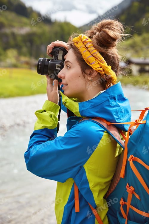 Preview: Wanderlust Woman Walks On Green Meadow In Mountains, Makes Wonderful Photos On Digital Camera