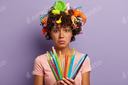 Preview: Sad Afro American Woman Holds Colorful Straws, Wants To Reduce Amount Of Plastic Waste In