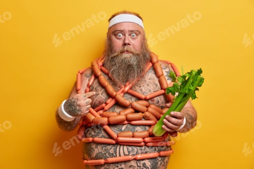 Preview: Shocked Obese Bearded Man Points At Himself And Looks With Bugged Eyes, Holds Celery And Wrapped