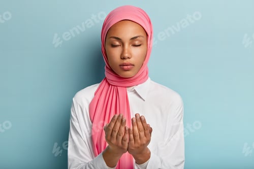 Preview: Arabic Faithful Dark Skinned Woman Keeps Hands In Praying Gesture, Asks Allah For Good Health