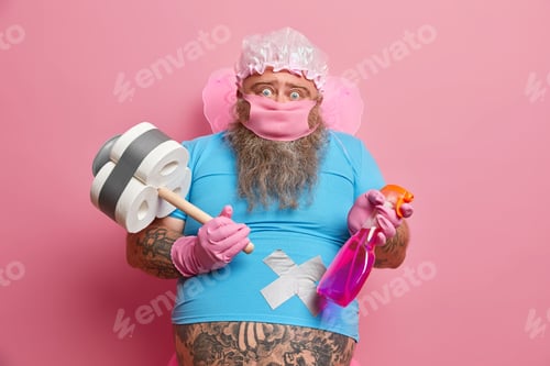 Preview: Fairy Ready To Work. Surprised Overweight Man In Funny Costume, Holds Detergent And Toilet Paper