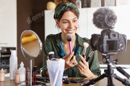 Preview: Candid Shot Of Beautiful Young Female Cosmetologist Tests New Kind Of Powder Brushes, Films Process