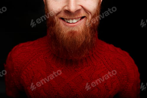 Preview: Closeup Portrait Of Long Red Beard And Mustache Man Smiling In A Red Knitted Sweater Isolated On