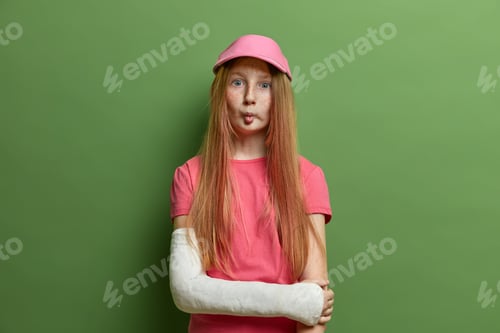 Preview: Cute Freckled Girl Makes Funny Face, Fish Lips, Has Long Straight Ginger Hair, Wears Rosy Cap And T