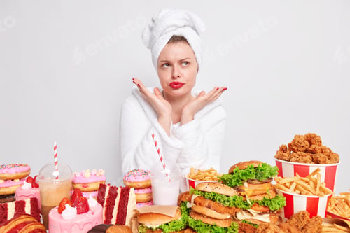 Preview: Hesitant Clueless Young Woman With Red Lipstick Domestic Clothes Spreads Palms Over Face Poses Near