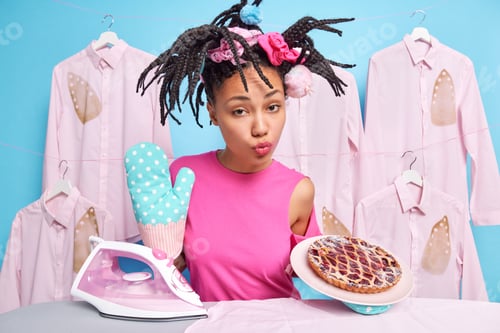 Preview: Serious Ethnic Housewife Keeps Lips Folded Wears Kitchen Glove Bakeed Deiciouspie Going To Iron