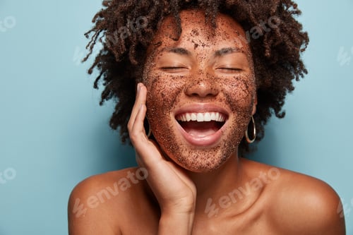 Preview: Satisfied African American Woman Has Pore Cleaning With Scrub Mask, Laughs Happily And Shows White