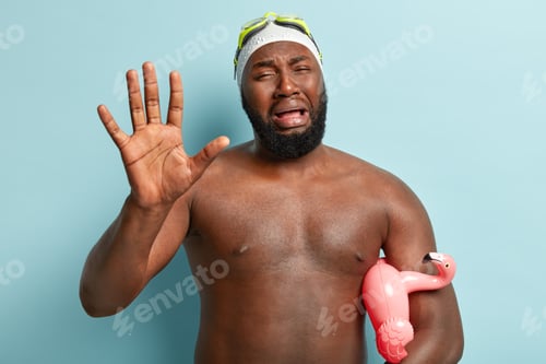 Preview: Sorrowful Displeased Dark Skinned Man Cries In Panic, Shows Palm At Camera, Frustrated To Have