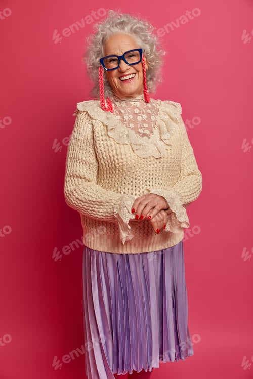 Preview: Positive Wrinkled Woman Wears Glasses, Stylish Clothes, Smiles Happily, Expresses Positive Mood
