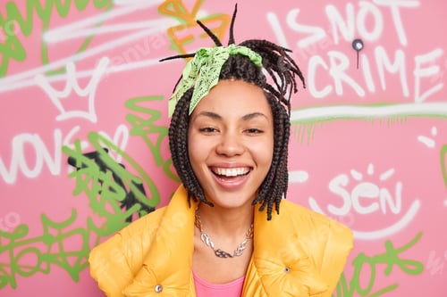 Preview: Positive African American Hipster Gurl Smiles Broadly Enjoys Spare Time Poses Against Colorful