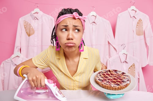Preview: Housekeeping And Domestic Chores Concept. Sad Distressed Dark Skinned Woman With Dreadlocks Holds