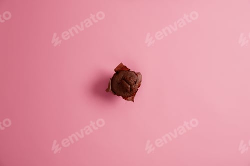 Preview: Just Baked Delicious Sweet Chocolate Muffin In Brown Paper Photographed From Above, Isolated On