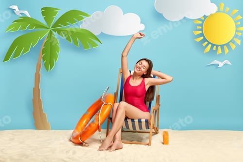 Preview: Satisfied Relaxed Beautiful Female Vacationist Stretches In Deck Chair, Wears Red Bikini, Has