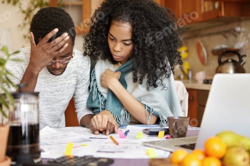 Preview: Young African-American Couple With Many Debts Calculating Gas And Electricity Bills While Doing