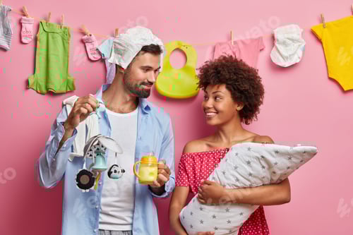 Preview: Couple Preparing Baby Items Together At Home