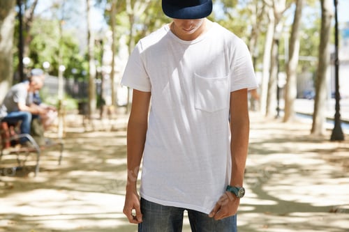 Preview: Portrait Of Teenage 15-Year Old Boy Wearing Cap Over His Eyes, Pulling Down His White Blank T-Shirt