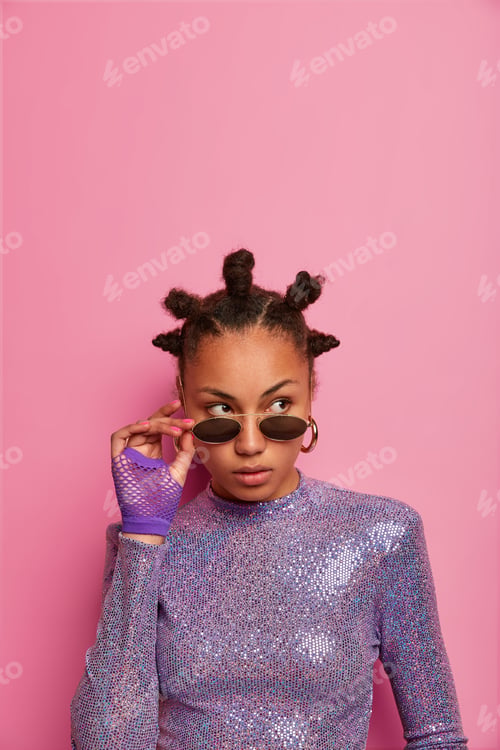 Preview: Serious Pensive Dark Skinned Woman Touches Sunglasses, Looks Somewhere Thoughtfully, Wears Purple