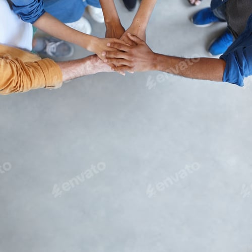 Preview: Horizontal Portrait Of Group Of People Standing Together Stacking Their Hands Showing Their Unity