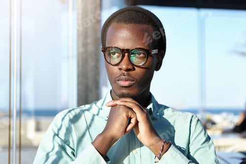 Preview: Close Up Portrait Of Fashionable Pensive Young European Dark-Skinned Man Wearing Hat And Hipster