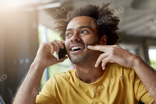 Preview: Picture Of Good-Looking Happy African Man With Beard And Curly Hair Smiling Cheerfully While