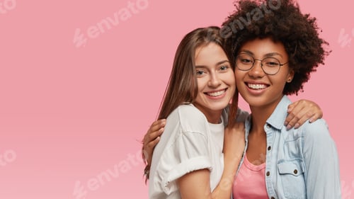 Preview: Multiracial Cheerful Young Best Friends Embrace Affectionately, Have Toothy Smiles, Stand Closely