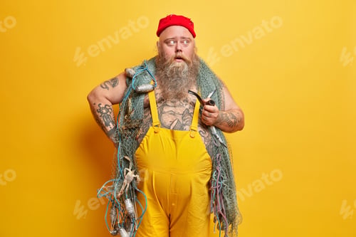 Preview: Pensive Experienced Sailor Concentrated With Curious Expression Aside, Smokes Pipe, Carries Fishing