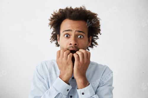 Preview: Headshot Of Scared And Frightened Young African-American Man With Afro Hairstyle And Stubble