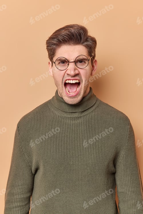Preview: Vertical Shot Of Emotional Annoyed Man Screams Loudly Keeps Mouth Opened Feels Outraged Has Quarrel