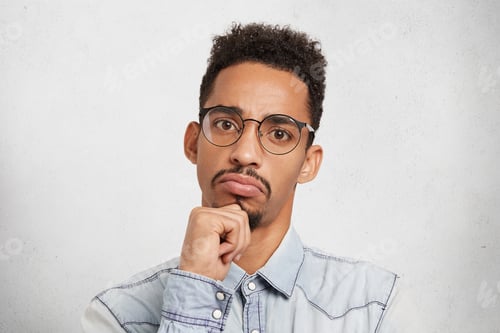 Preview: Hmm Not Bad. Close Up Studio Portrait Of Concentrated Seruious Male Manager Or Boss Evaluates Work