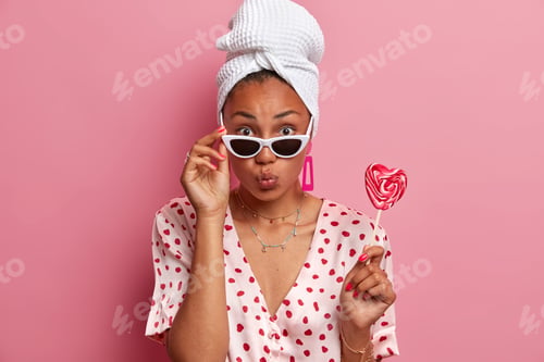 Preview: Attractive Ethnic Lady Wears Stylish Sunglasses Domestic Silk Robe And Bath Towel On Head Holds
