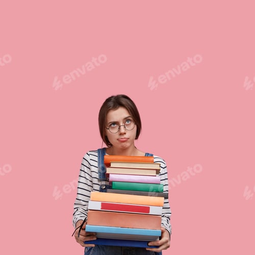 Preview: Indoor Shot Of Contemplative Dissatisfied Lady Carries Piles Of Books, Wears Optical Glasses, Looks