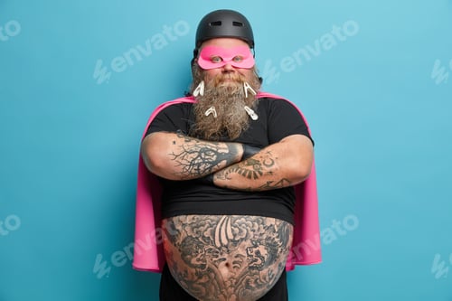 Preview: Confident Bearded Male Superhero Stands With Arms Folded Participates In Organization Childrens