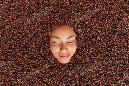 Preview: Aromatic Roasted Brown Coffee Beans Around Face Used As Skin Scrub. Human Model Going To Prepare
