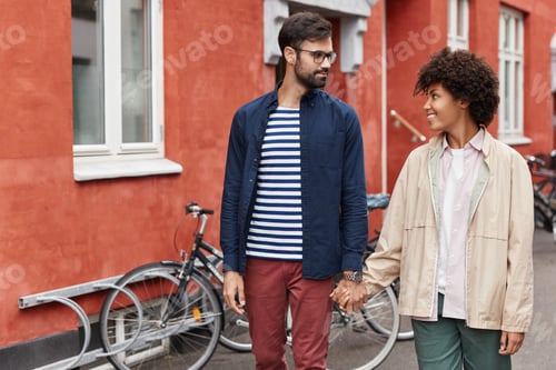 Preview: Mixed Race Lovely Young Couple Have Walk Outdoor, Hold Hands, Look At Each Other With Love And