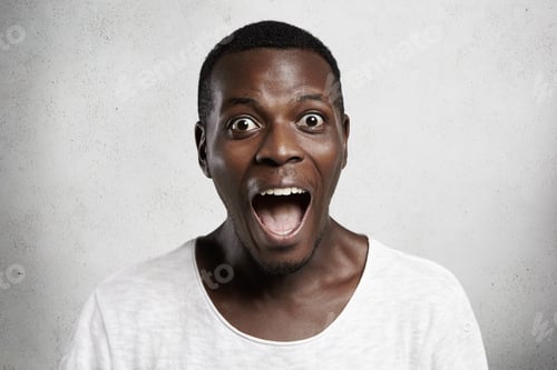 Preview: Omg! Portrait Of Astonished Wide-Eyed African Customer In White T-Shirt Looking At Camera In
