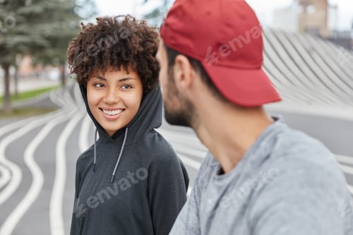 Preview: Smiling Satisfied Ethnic Cute Girl In Hoody Has Pleasant Friendly Talk With Handsome Guy, Walk