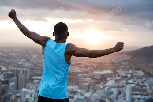 Preview: Carefree Independent Man With Dark Skin, Stands Back At Camera, Stretches Hands As Holding World