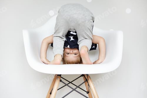 Preview: Happy And Carefree Childhood. Playful And Fidgety Baby Boy Dressed In Gray Pants And Striped