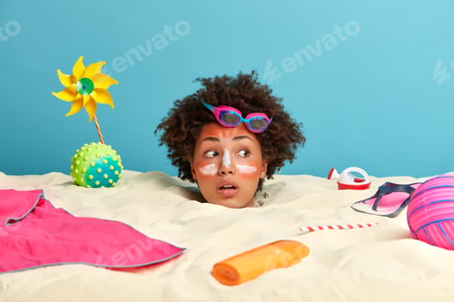 Preview: Sunbathing, Vacation And Recreation Concept. Surprised Curly Haired Young Woman Sunbathes By Sea